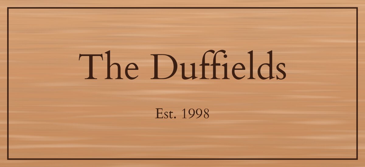 The Duffields, Est. 1998, filled engraving on cedar